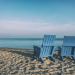 Retirement Beach - two blue beach chairs near body of water