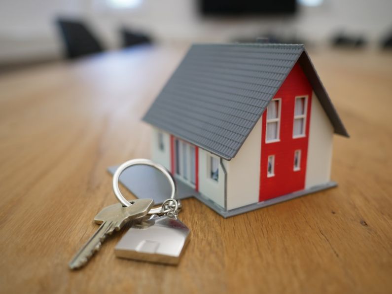 Real Estate Agent - white and red wooden house miniature on brown table
