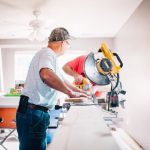 DIY Management - man standing infront of miter saw