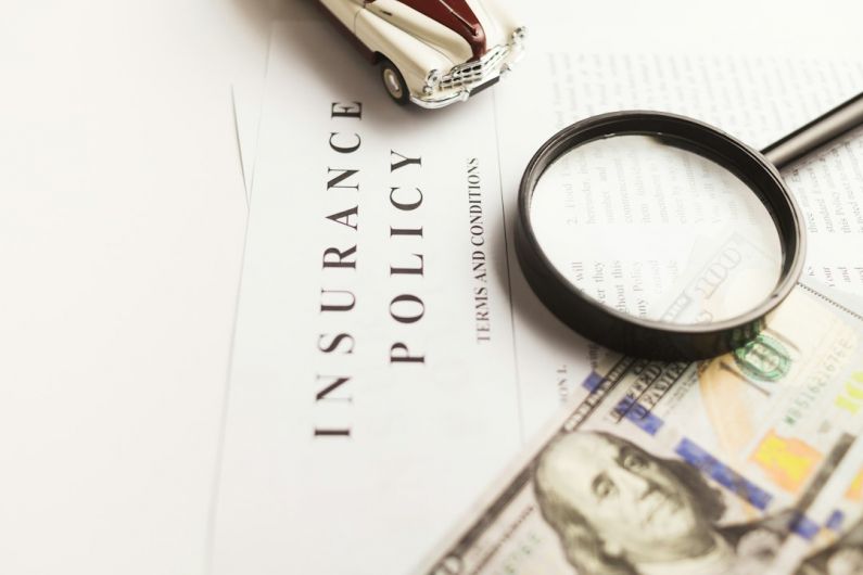 Insurance Policy - a magnifying glass sitting on top of a piece of paper