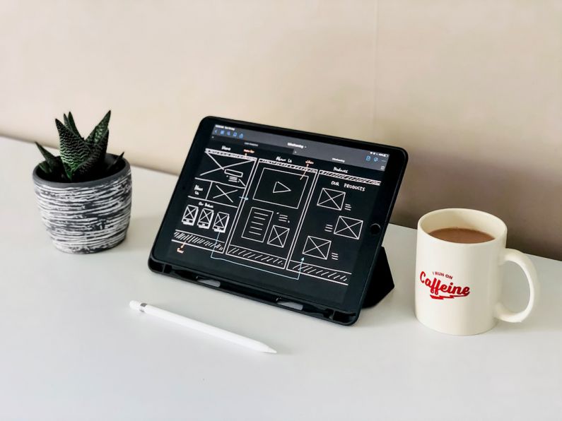 Website Design - black ipad beside white ceramic mug on white table