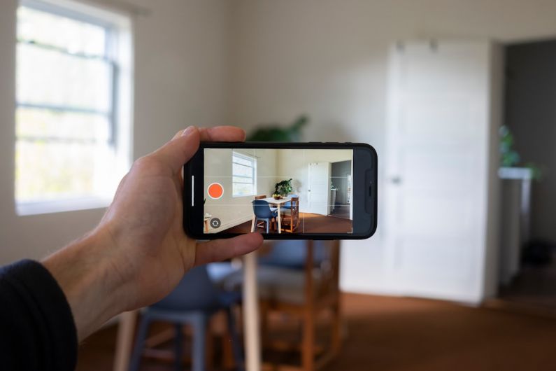 Virtual Tour - a person holding a smart phone up to take a picture