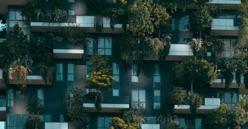 Green Investment - Modern residential building facade decorated with green plants