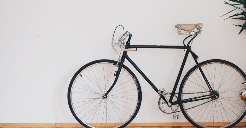 Economic Cycle - Black Fixed-gear Bike Beside Wall