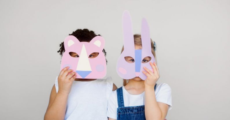 Innovative Materials - Two Kids Covering Their Faces With a Cutout Animal Mask
