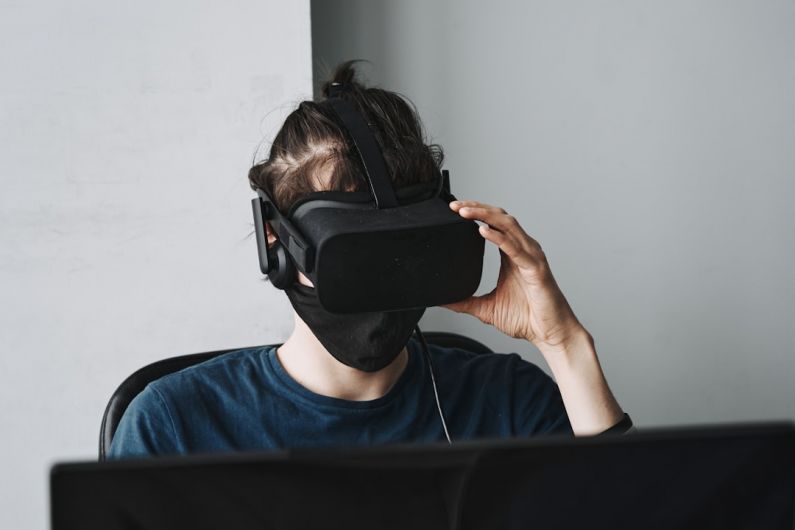 AI Trends - man in blue crew neck shirt wearing black vr goggles