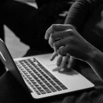 Online Marketplace - grayscale photo of person using MacBook