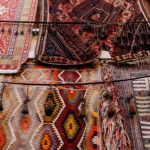 Middle East Market - Colorful handmade weaved with oriental ornament middle east rugs hanging in open market
