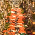 Emerging Market - A city street with many umbrellas and buildings
