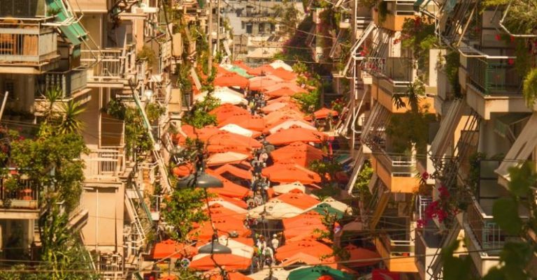Emerging Market - A city street with many umbrellas and buildings