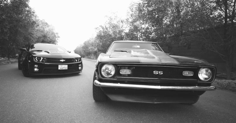 Cultural Difference - Modern and retro cars on asphalt road