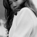Portfolio Building - A woman in a white coat standing on a balcony
