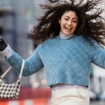 First-time Buyer - Happy woman jumping with shopping bags