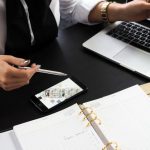 Real Estate Agent - Person Pointing on the Screen of a Laptop