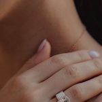 Lowball Offer - Crop woman with gold earings demonstrating hand with manicure and precious ring on ring finger