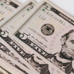 Capital Gains Tax - Heap of money on white surface