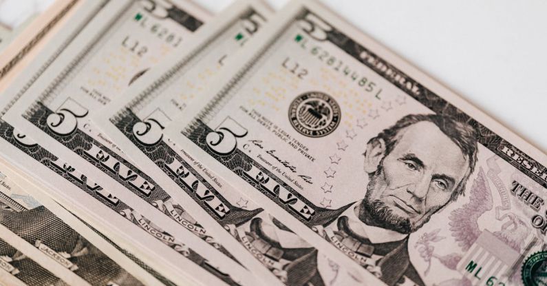 Capital Gains Tax - Heap of money on white surface