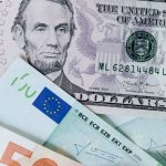 Rental Profit - From above of chaotic pile of dollar banknotes and euro cash