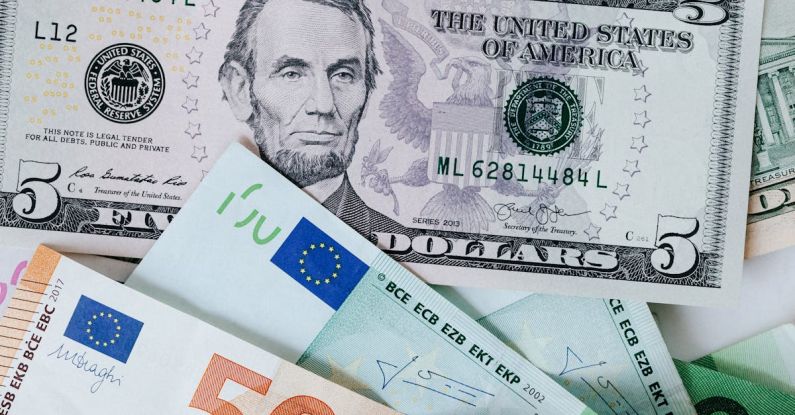 Rental Profit - From above of chaotic pile of dollar banknotes and euro cash