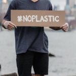 Pet Policy - Man in Black Crew Neck T-shirt Holding the Beach Signage