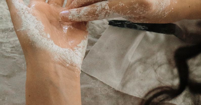 DIY Management - A woman's hands are covered in white powder