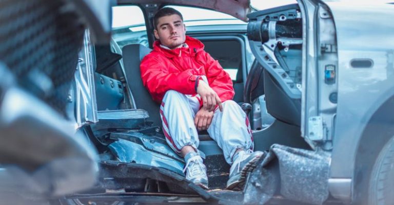 Emergency Repair - Man in Red Coat Sitting on Broken Car Seat