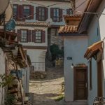 Urban Rural - A narrow street with houses and trees