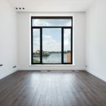 Co-living Space - Interior of modern spacious light room with wooden laminate floor white walls and panoramic windows