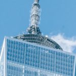 World Investment - Low angle of modern high One World Trade Center with high telecommunication tower in Manhattan