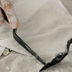 Management Tools - A person is using a pair of scissors to cut a piece of paper