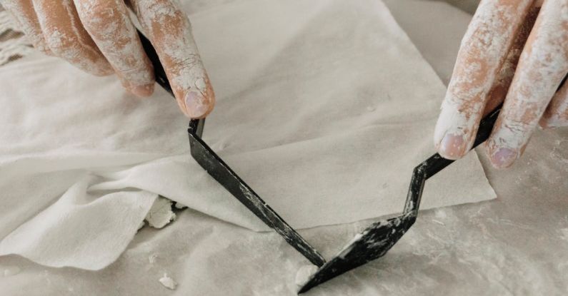 Management Tools - A person is using a pair of scissors to cut a piece of paper