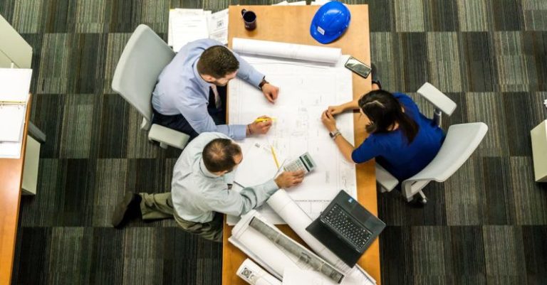 Tech Management - Three People Sitting Beside Table