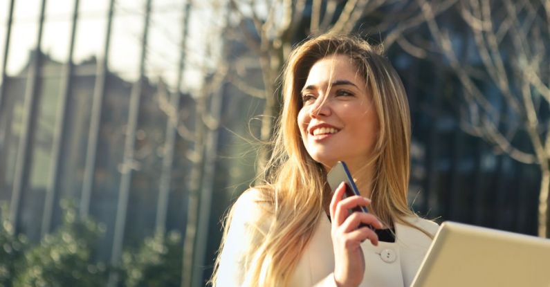 Tech Real Estate - Woman Wearing White Top Holding Smartphone and Tablet