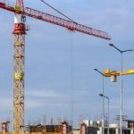 Construction Technology - Three Yellow and Red Tower Cranes Under Clear Blue Sky