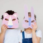 Innovative Materials - Two Kids Covering Their Faces With a Cutout Animal Mask