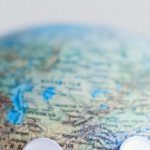 Globalization Impact - Model of globe with googly eyes representing Earth as character with need of protection