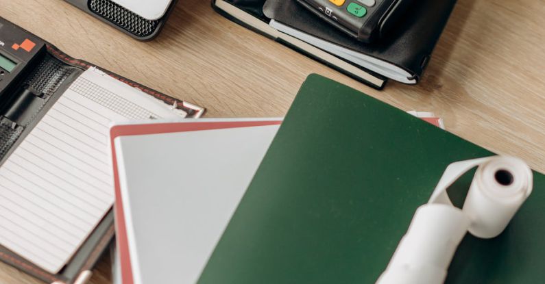 Tech Management - Computer Laptop and Notebooks on a Wooden Desk